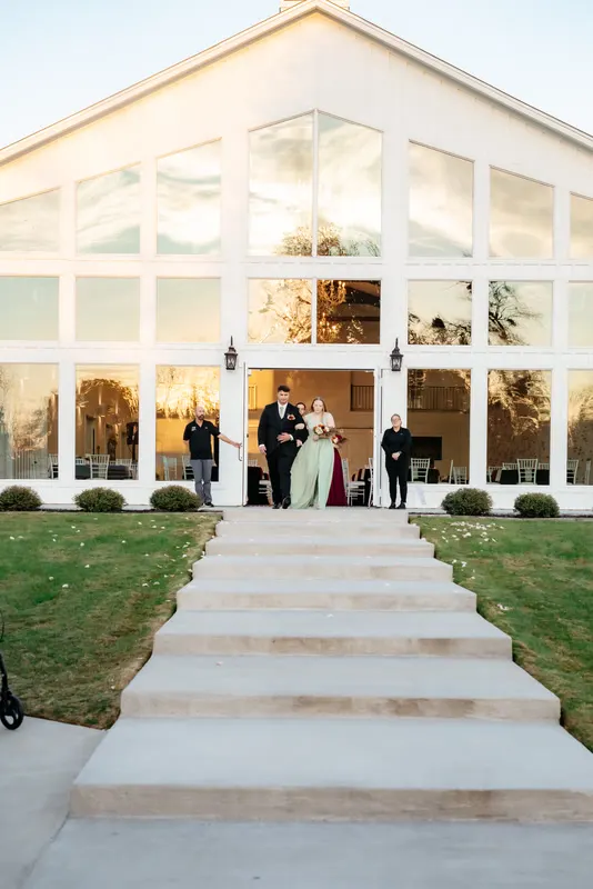 White glass wedding venue with a stone path